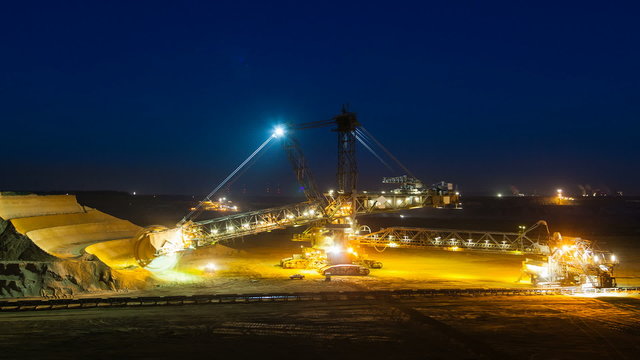 Timelapse sequence of a giant Bucket Wheel Excavator at work in an endless lignite pit mine at night