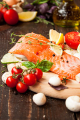 свежая рыба с овощами на деревянном столе