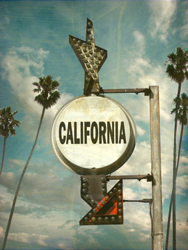aged and worn vintage photo of california sign with palm trees