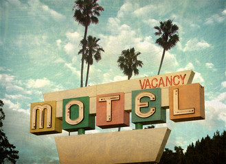 ged and worn vintage photo of retro motel sign with palm trees - obrazy, fototapety, plakaty
