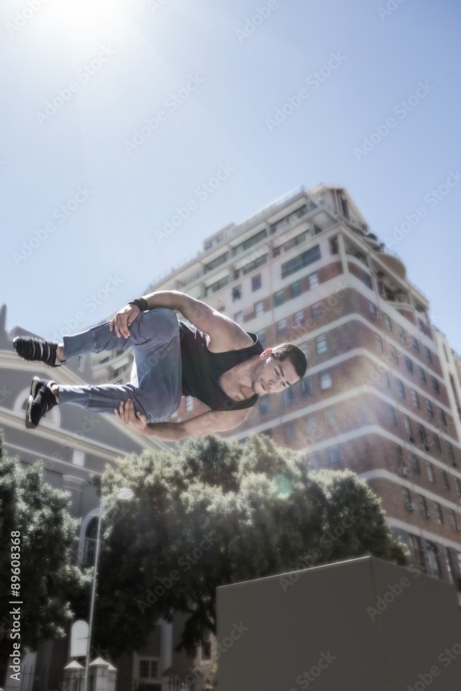Poster man doing free-running in the city