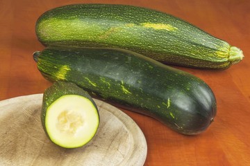 Growing vegetables in the organic farm. Vegetables grown in a small home garden. Old metal weight on homemade food. Background with vegetables. Promotion of healthy diets, diet food preparation.
