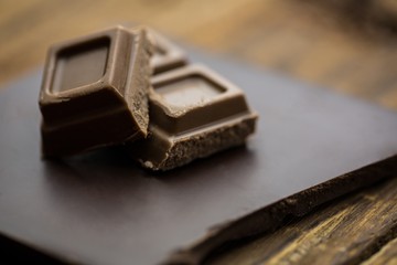 Dark and milk chocolate on a wooden table