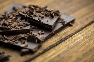 Pieces of chocolate on a wooden table