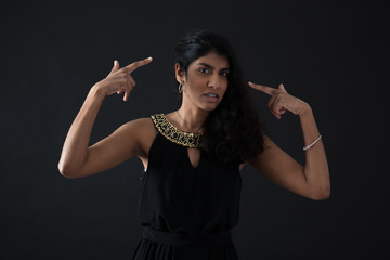 Obraz premium Beautiful woman doing different expressions in different sets of clothes: you are crazy