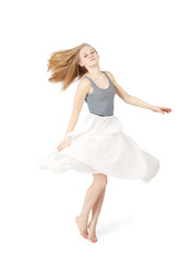 Naklejka premium Young blond woman in skirt dancing with long hair on white background isolated