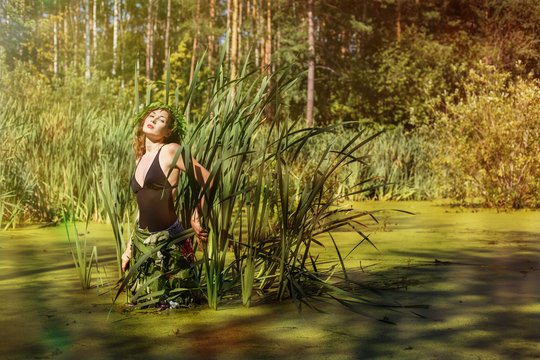Beautiful woman in Green pond and Leaves. Natural cosmetics, Spa, Beauty