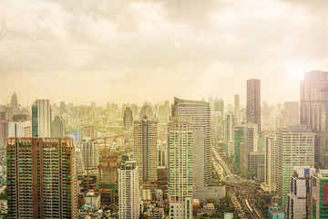 Vintage image of Bangkok City skyline. Skyscrapers and traffic road