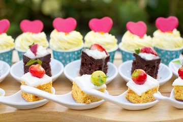 Luxury Sweet Buffet Dessert for Holiday with pink Love Hearts on small Cakes Outdoor