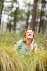 Young pretty hiker sitting in the high grass