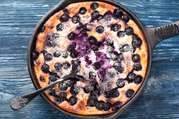 Close-up Cottage cheese casserole Cheesecake with blueberries in pan. top view