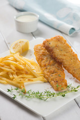 Fish and chips. Fried fish fillet with french fries wrapped by p