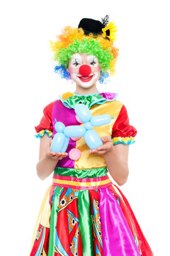 Beautiful young woman as colorful clown