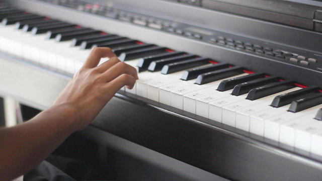 A child's hand playing the piano
