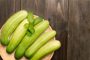 Raw cucumber on wooden background