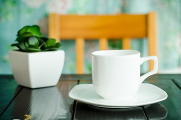 Cup of hot coffee on the table in the cafe