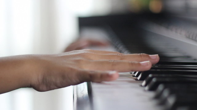 A child's hand playing the piano
