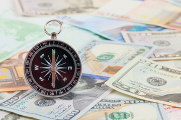 compass on the pile of money