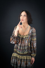 Fototapeta premium Beautiful woman doing different expressions in different sets of clothes: thinking