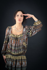 Beautiful woman doing different expressions in different sets of clothes: at attention