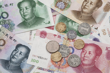 A collage of Chinese RMB bank notes and coins