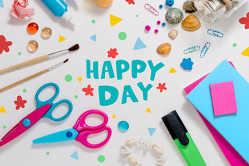 Photo of workplace with lots of stationery objects, shells and l