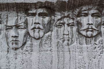 Human Faces Carved in Black Stone