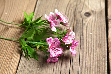 beautiful flowers lie on old wooden table