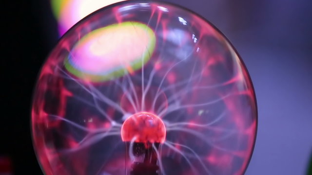 Hands touch the plasma ball. Tesla coil.