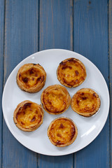 portuguese cookies on white dish on blue background