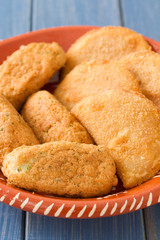 meat and cod fish croquete on dish on blue wooden background