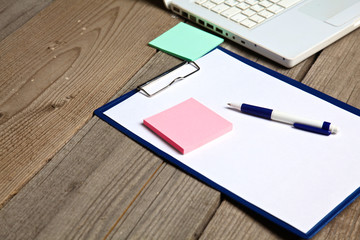 Notebook and laptop on old wooden desk