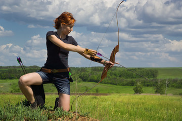 Archery woman bends bow archer target narrow