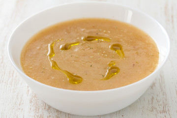vegetable soup with oil in white bowl