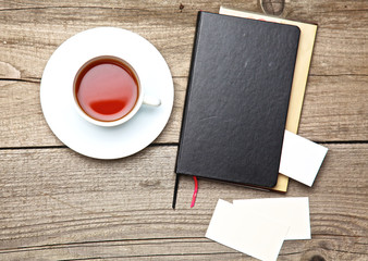 Obraz na płótnie Canvas laptop, tea, business card with pen on old wooden desk