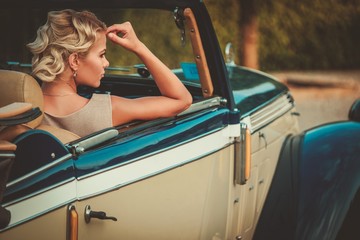Beautiful lady passenger in a  classic convertible - obrazy, fototapety, plakaty