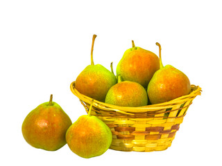 Pears are in the basket. Two pears lie nearby. Composition on a white background.