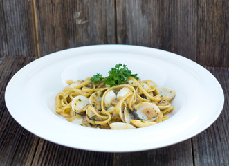 Spaghetti alla vongole on a wooden background