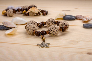 Bracelet handmade crochet beads with pendant starfish on a woode