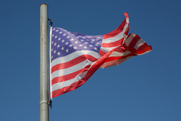 American flag under blue sky