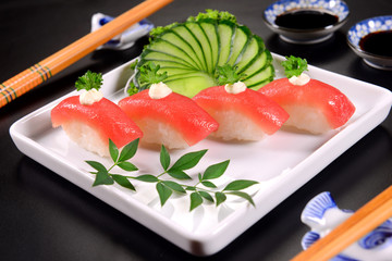 Four salmon nigiri on squared background