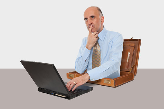 Business man working with his laptop at desk