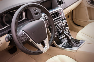Black luxury car Interior - steering wheel, shift lever and dash