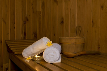 Fototapeta na wymiar Sauna bench with white towels and bucket