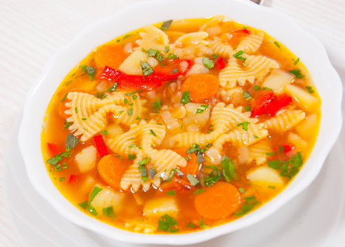Fresh vegetable soup with farfalle pasta