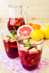Fototapeta na wymiar Homemade delicious red sangria with limes oranges, apples and gr