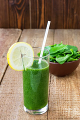 Healthy green smoothie with spinach on wooden backround