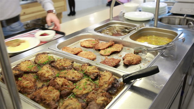 Lunch in the canteen. The waiter serves visitors.