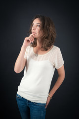 Fototapeta premium Beautiful woman doing different expressions in different sets of clothes: thinking