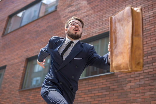 Young Businessman Running In A City Street